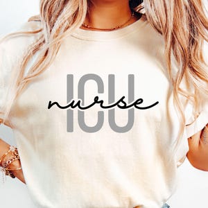 May include: White t-shirt with the text "ICU nurse" in black and gray lettering.