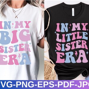 May include: Two t-shirts with a retro-style graphic design. The white t-shirt says "In My Big Sister Era" in pink and blue letters. The black t-shirt says "In My Little Sister Era" in pink and blue letters.