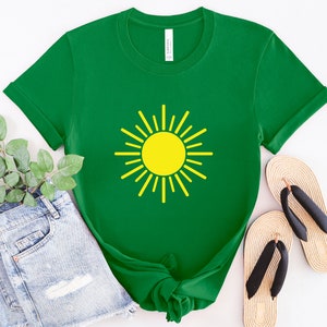 May include: A green t-shirt with a yellow sun graphic. The shirt is made of a soft, comfortable material and has a crew neck.