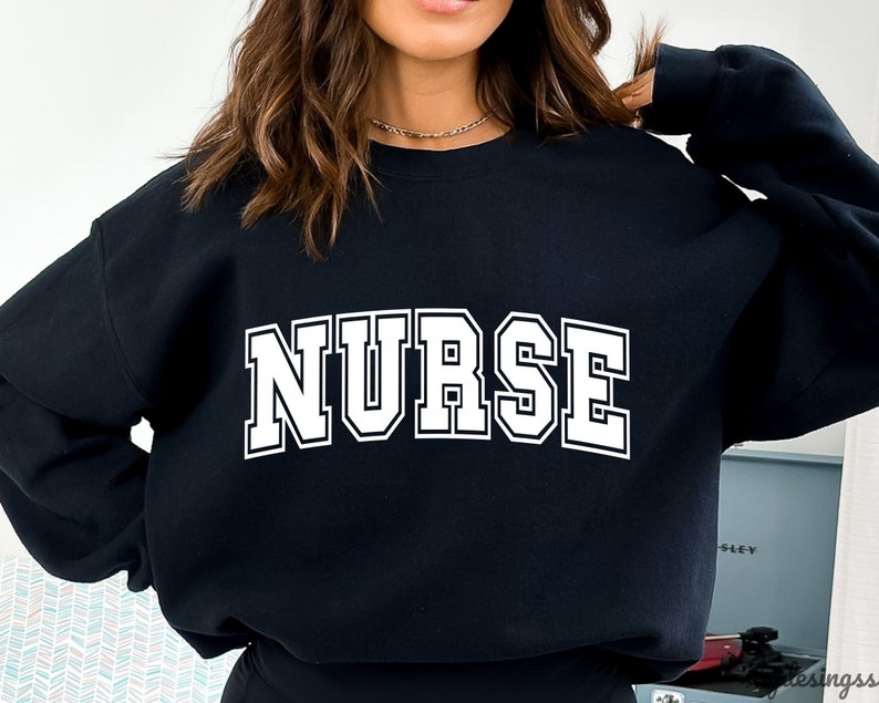 May include: Black sweatshirt with the word "NURSE" printed in white block letters.