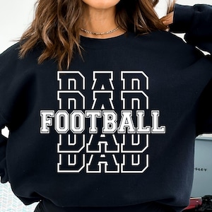 May include: Black sweatshirt with white text that reads "DAD FOOTBALL DAD" in a stacked, bold font.