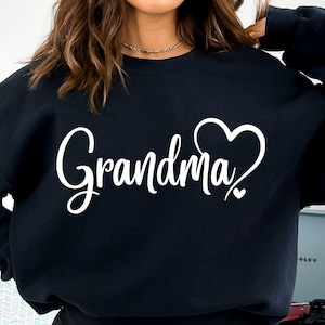 May include: Black sweatshirt with the text "Grandma" in white cursive lettering and a white heart design.