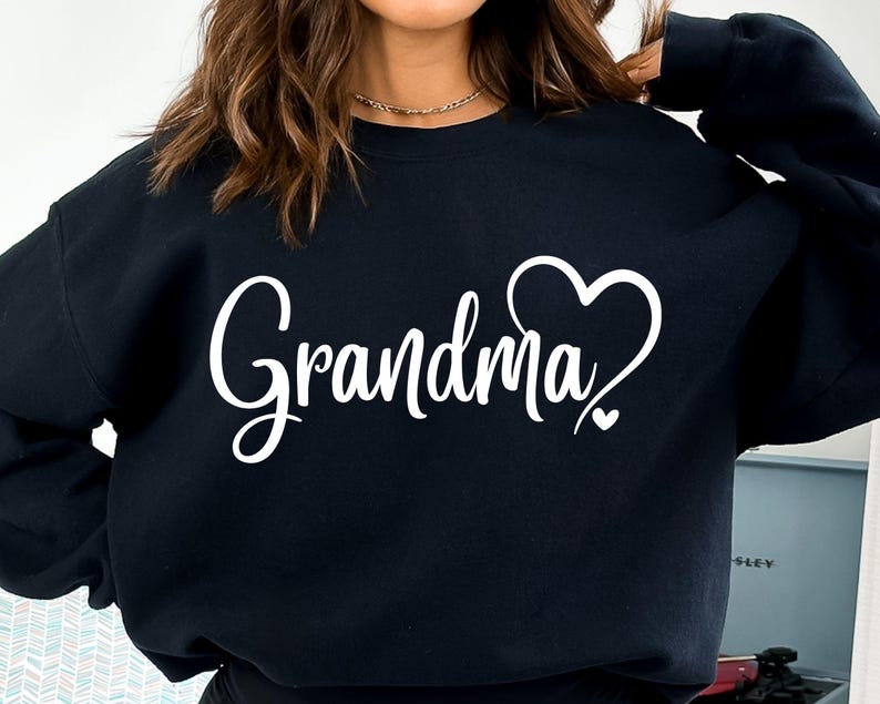 May include: Black sweatshirt with the text "Grandma" in white cursive lettering and a white heart design.