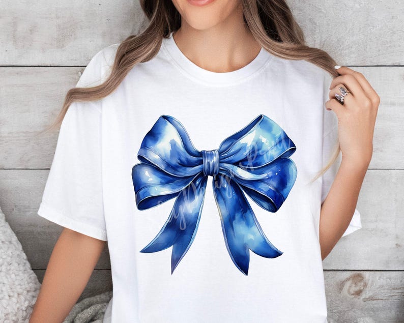 May include: A white t-shirt with a large blue watercolor bow design.