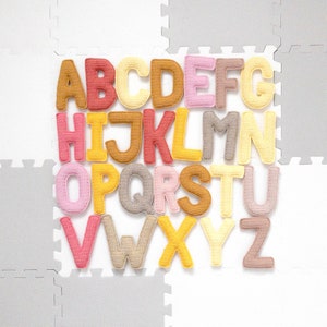Crochet alphabet letters from a crochet alphabet pattern, suitable as a Montessori toy for learning letters.