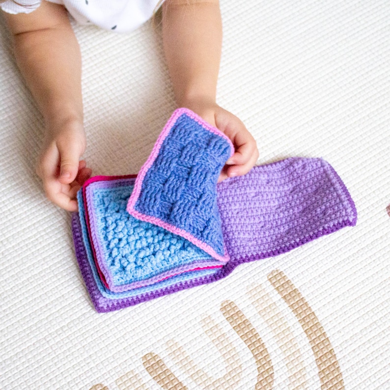 Child enjoying a handmade crochet book designed from a pattern, perfect for learning and tactile exploration.