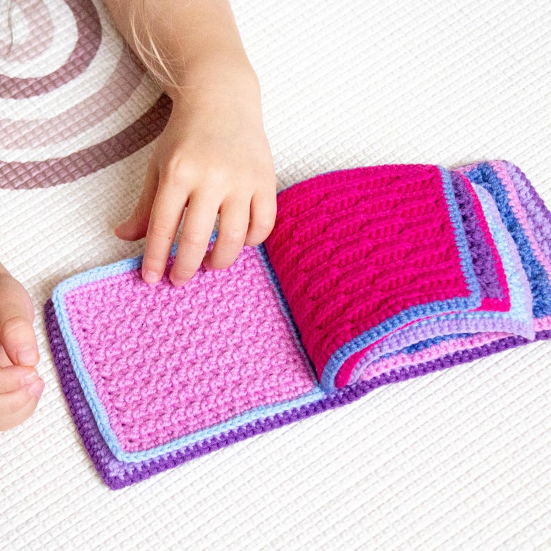 Crochet sensory book in action, made using a detailed crochet pattern, ideal for developing fine motor skills.
