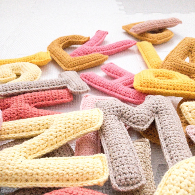 Detailed view of crochet uppercase letters from a crochet alphabet pattern.