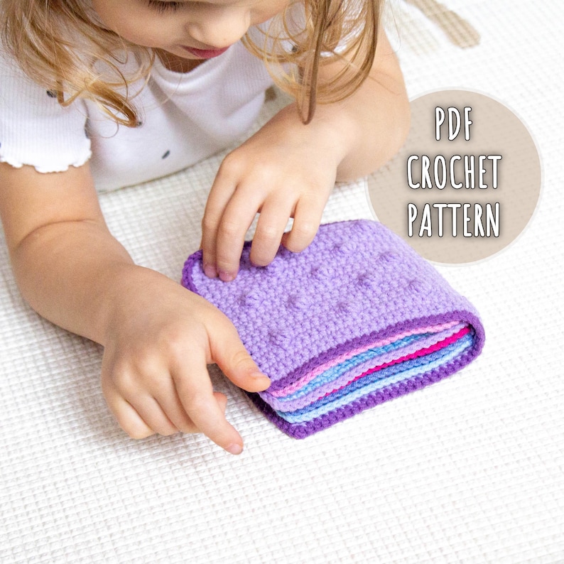 Kid playing with a handmade crochet sensory book created from a detailed PDF crochet pattern, perfect for Montessori-inspired sensory play and fine motor skill development.