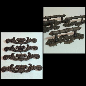 May include: Ornate, dark brown metal drawer pulls and handles. The drawer pulls have a scrolling, decorative design. The handles have a bamboo-like texture. The hardware is likely for furniture restoration or a vintage aesthetic.