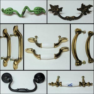 May include: A collection of cabinet hardware, including drawer pulls and handles. Styles include a green leaf design, ornate bronze, gold, and black finishes. Some pulls have white ceramic handles with gold accents, and one features a blue floral pattern.