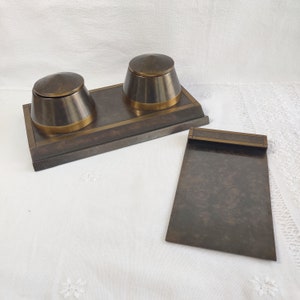 May include: A set of three ceramic mugs with a speckled, cream-colored glaze. Each mug features a different hand-painted floral design in shades of blue, green, and yellow. The mugs have a simple, modern shape.