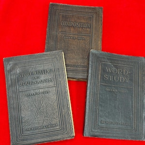May include: Three vintage books with embossed covers are arranged on a red background. The titles include "Composition," "Story Writing and Journalism," and "Word Study." The books are from The Nettel Library.