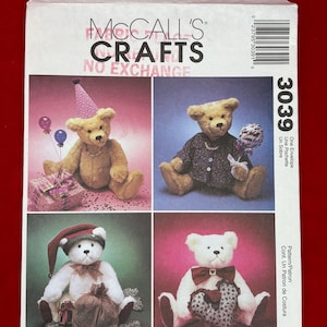 May include: A McCall's Crafts sewing pattern envelope 3039 featuring four teddy bears. One bear wears a pink party hat, one wears a dark jacket with a Get Well Soon balloon, one wears a red cap, and one holds a heart-shaped pillow.