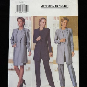 May include: A white ceramic mug with a black handle and the text "But First, Coffee" in a handwritten style. The mug is on a white surface. The mug is 4 inches tall.