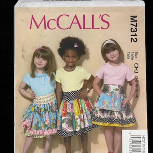 May include: McCall's M7312 sewing pattern featuring three young girls wearing colorful skirts. The pattern includes sizes CHJ (7-8-10-12-14). The image also shows the price and item number.