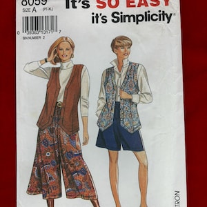 May include: Simplicity pattern envelope featuring illustrations of two women in 1970s-style outfits. The envelope is white with the text "It's SO EASY it's Simplicity" in red and black. The pattern number is 8059, size A (PT-XL).