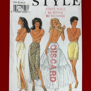 May include: A 1992 Style Patterns sewing pattern envelope, number 2253, size A SM-LG. The front features illustrations of four skirt styles: a long slit skirt, a patterned skirt, a full-length petticoat, and a short skirt with lace trim.