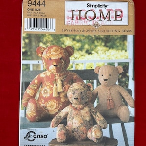 May include: A Simplicity 9444 sewing pattern envelope for 19-inch and 25-inch sitting bears. The cover features three stuffed bears with floral and checkered fabric patterns, including tassels, with the text Simplicity Home 9444.