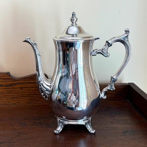 May include: A rustic wooden sign with the text "Welcome to our home" in white lettering. The sign features a distressed finish and a simple, inviting design, perfect for a front porch or entryway.