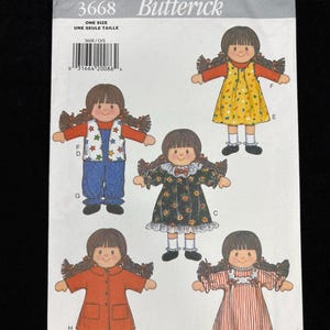 May include: Butterick 3668 sewing pattern envelope. The envelope features illustrations of a doll with various outfits, including a yellow dress with polka dots, a red coat, and a striped dress. The text "ONE SIZE" is visible.