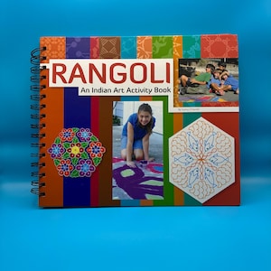 May include: A spiral-bound book titled "RANGOLI An Indian Art Activity Book" with colorful illustrations and photographs. The cover features a vibrant design with the word "RANGOLI" in large white letters.