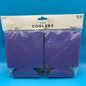 May include: A package of six purple can coolers. The coolers are made of a foam-like material and are packaged in a clear plastic bag. The package has a white header with the words "CAN COOLERS" printed in black.