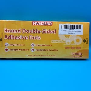 May include: A yellow box of round double-sided adhesive dots. The box features the text "FIVEIZERO" and "Round Double-Sided Adhesive Dots." It also lists features like "Easy to Remove" and "Water Resistance." The box contains 10 rolls with 1000 dots.