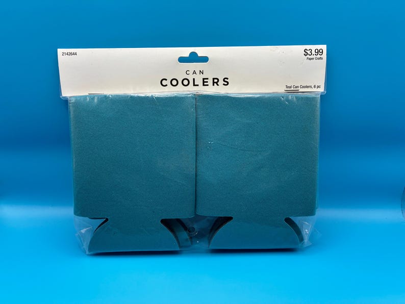 May include: Teal can coolers, packaged in clear plastic. The package includes six can coolers. The top of the package has the words "CAN COOLERS" printed in black. The background is a solid blue.