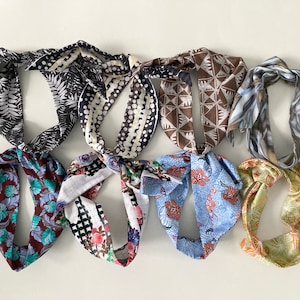May include: Eight colourful patterned headbands with different designs, including floral, geometric and abstract patterns.