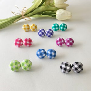May include: Assortment of colourful gingham fabric button earrings. The earrings are in pairs and come in yellow, pink, blue, green, and black and white.