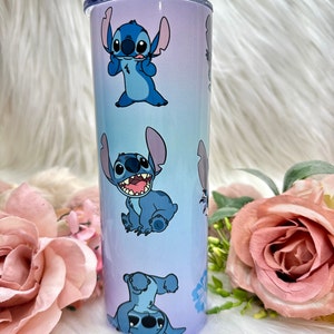 May include: A blue and purple stainless steel tumbler with a repeating pattern of Stitch, a blue alien character from the Disney movie Lilo & Stitch.