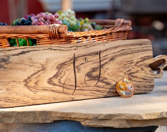 Large Charcuterie Board with Carved Word "Joy" on It