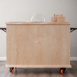 Charcuterie cart with wooden top and stainless steel containers and wooden boards