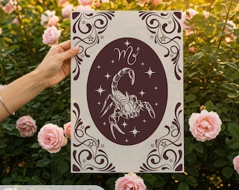 May include: A rectangular wall art print featuring a Scorpio zodiac design. The artwork has a beige background with a maroon oval containing a scorpion illustration and the Scorpio symbol. Decorative maroon swirls and stars frame the design. The text "Starwild Printable Wall Art" is at the bottom.