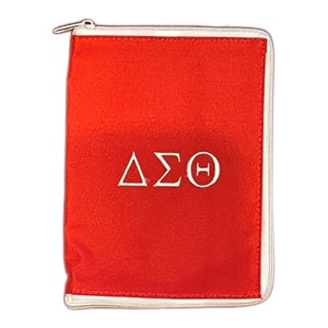 May include: Red zippered pouch with white embroidered Greek letters "ΔΣΘ"