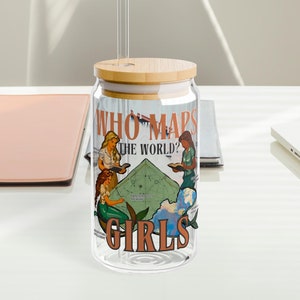 May include: A clear glass reusable can with a bamboo lid and a straw. The can has a graphic of three women looking at a map with the text "Who Maps the World? Girls".