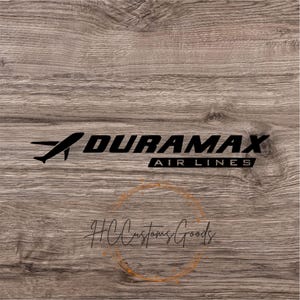 May include: Black and white decal of a plane with the text "DURAMAX AIRLINES" on a wood background.