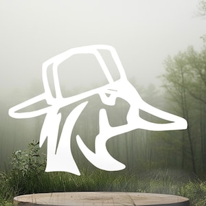 May include: A white graphic illustration of a duck head wearing a baseball cap, depicted in a clean, minimalist line art style. The design features the profile of a duck with a bill and a cap, rendered in solid white against a blurred natural background.