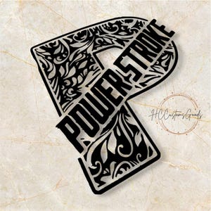 May include: A black cutout of the letter P featuring intricate filigree patterns and the word POWERSTROKE integrated into the design. The letter has a bold, stylized appearance with a decorative scrollwork motif throughout the entire shape.