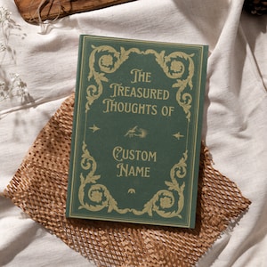 May include: A green journal with gold accents and the text "The Treasured Thoughts of CUSTOM NAME" on the cover.