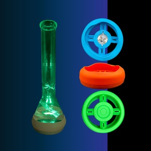 May include: A green glass bong with a round base and a blue, orange, and green silicone bowl piece. The bowl piece has the text "Glowguard" printed on it.