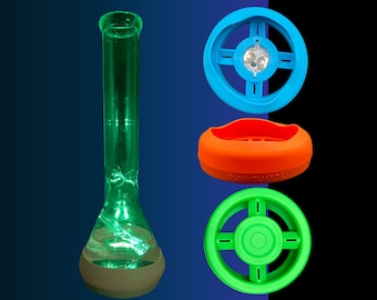 May include: A green glass bong with a round base and a blue, orange, and green silicone bowl piece. The bowl piece has the text "Glowguard" printed on it.