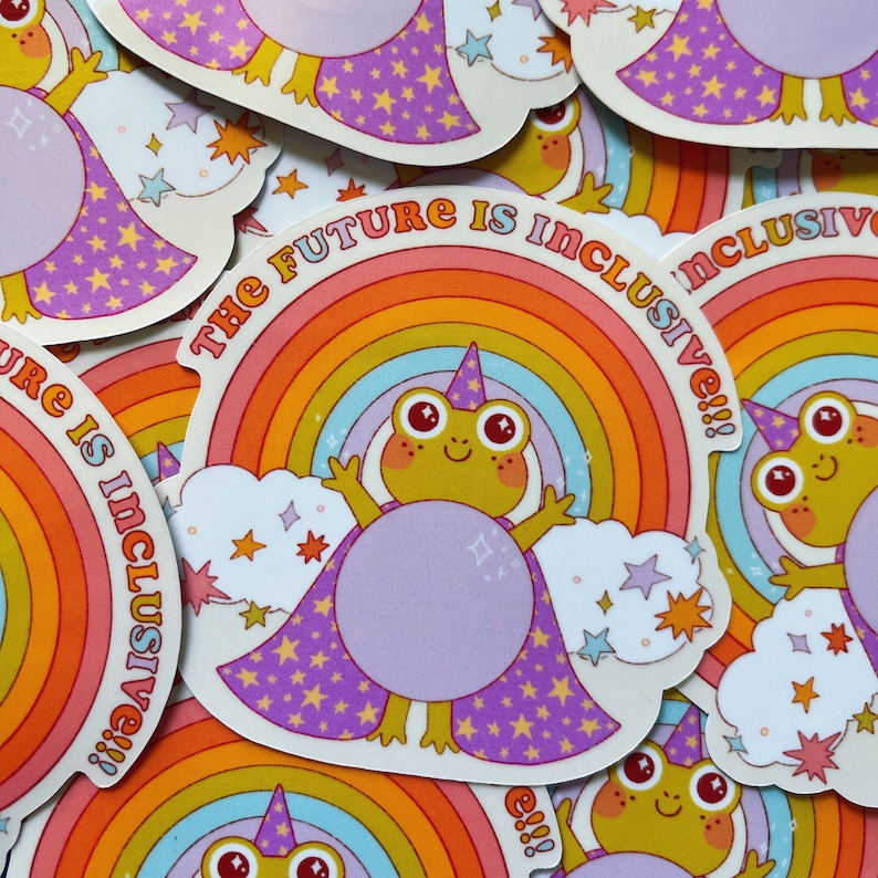 May include: A sticker with a rainbow and a frog wearing a purple cape and a wizard hat. The text on the sticker says "The Future is Inclusive!!!"