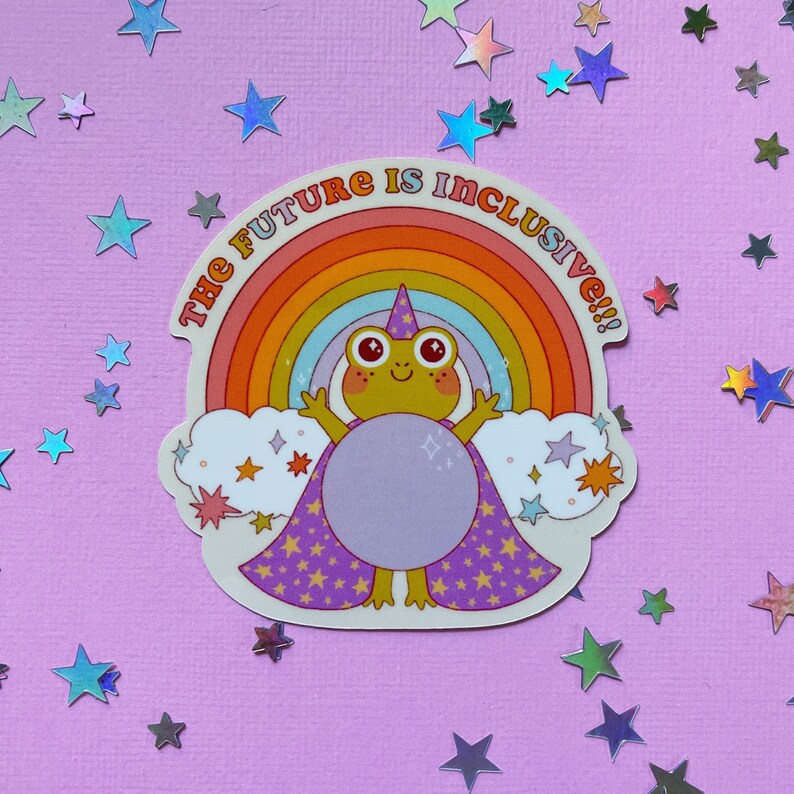 May include: A sticker featuring a frog wearing a wizard hat and a purple cape with stars. The frog is standing in front of a rainbow with the text "The Future is Inclusive!!!" above it.