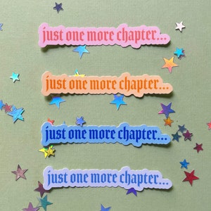 May include: Four stickers with the text "just one more chapter..." in a gothic font. The stickers are in different colors: pink, orange, blue, and purple.