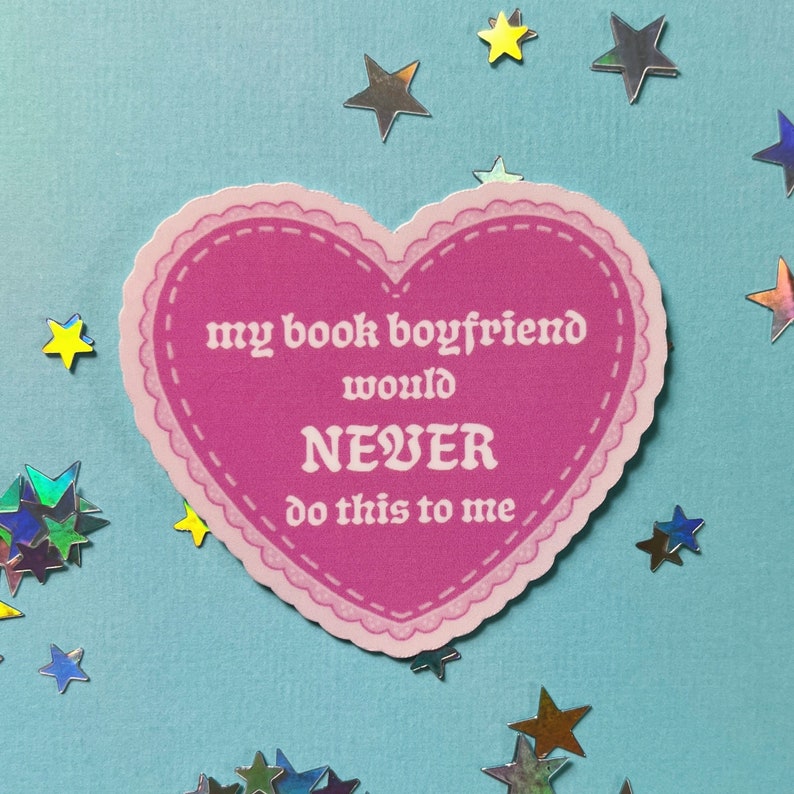 May include: Pink heart-shaped sticker with the text "my book boyfriend would NEVER do this to me".