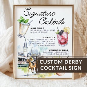 May include: A white ceramic mug with a black handle and the text "But First, Coffee" in a bold, black font. The mug is sitting on a wooden surface. The mug is approximately 4 inches tall.