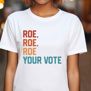 a woman with a white t - shirt that says rose rose, your vote