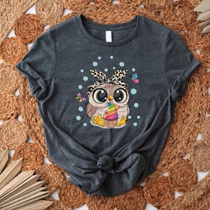 a women's t - shirt with an image of an owl on it